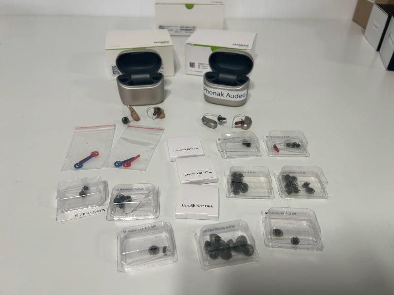 Phonak hearing aids and a variety of domes, cleaning tools, and other accessories