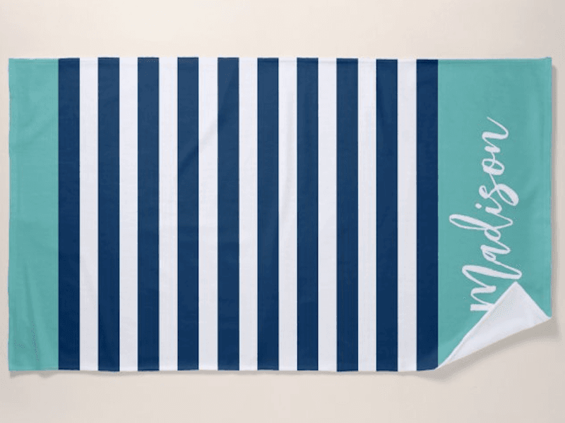 Nautical print beach towel with the name Madison written in script at the bottom