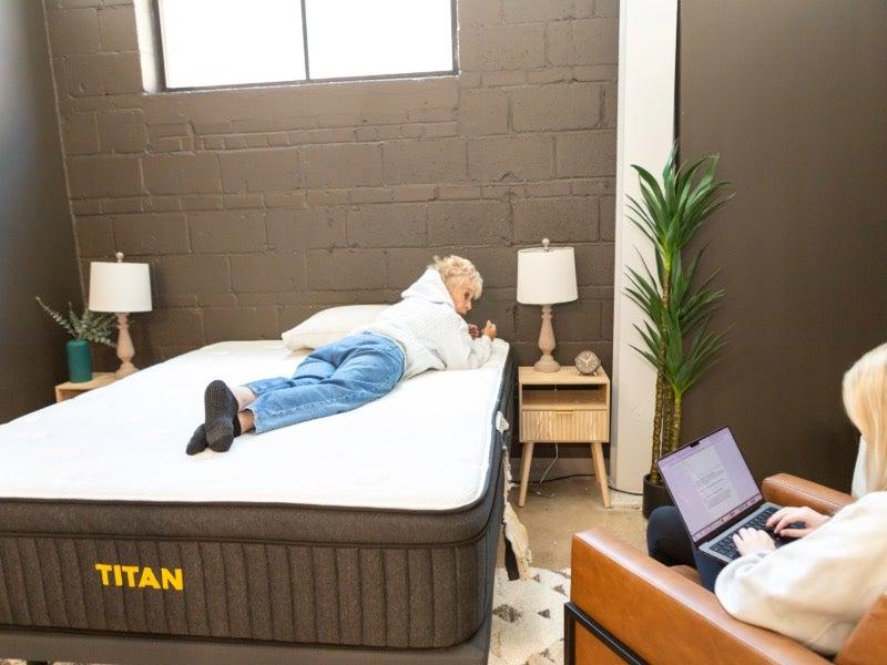 A woman rolling over on the Titan Plus Luxe mattress