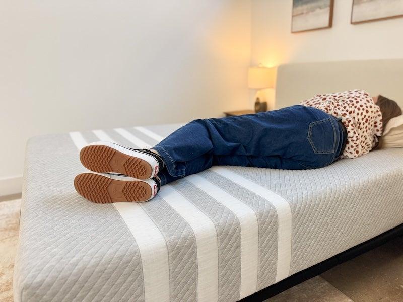 A woman lies on her side on the Leesa Original memory foam mattress