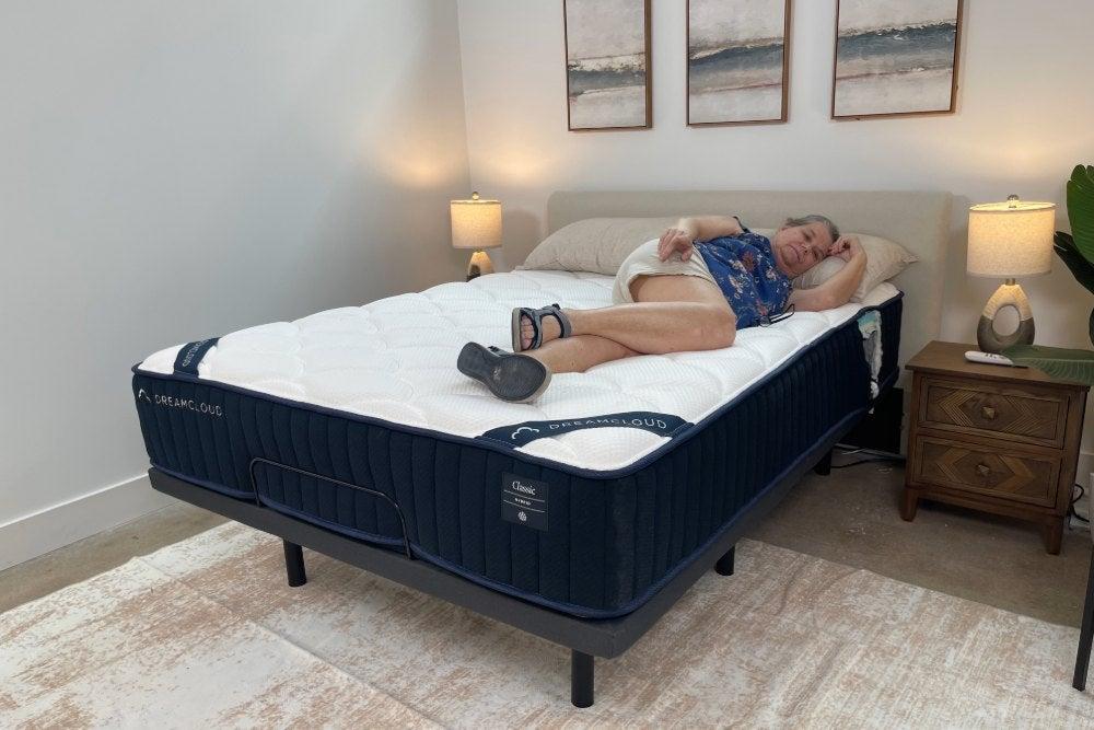 Woman lies on her side on the DreamCloud Classic Hybrid mattress