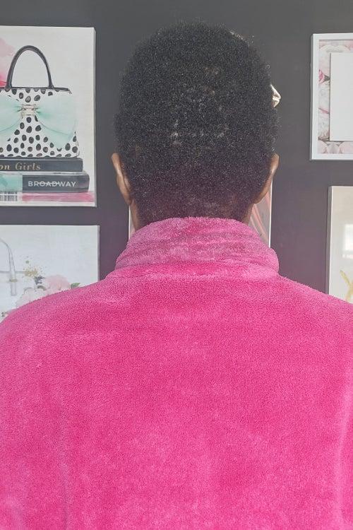 The back of a woman's head, showing some areas of thinning hair