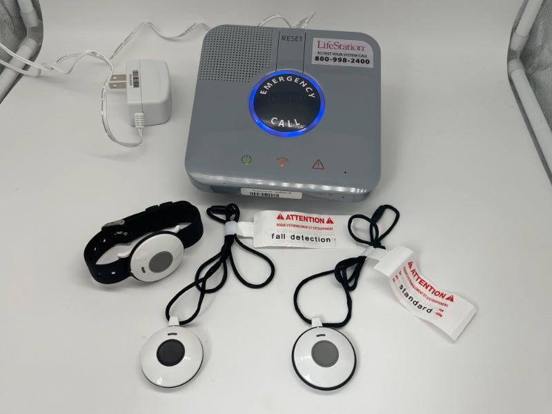 The LifeStation Sidekick Home base station and three wearable buttons