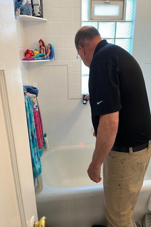 American Standard staff measuring a tub