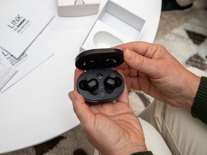 The Eargo Link earbud-style hearing aid in its charging case.