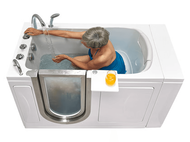 Woman in blue bathing suit relaxes in her Ella’s Bubbles walk-in tub