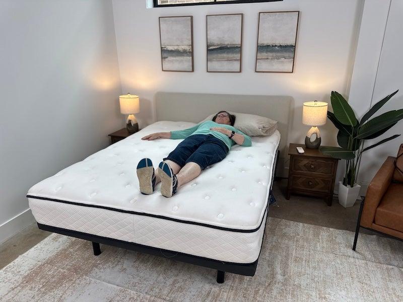 A woman lying on her back on the Winkbeds GravityLux mattress.