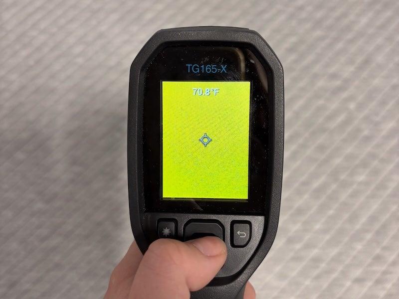 A heat gun shows a reading of 70.8 degrees F.