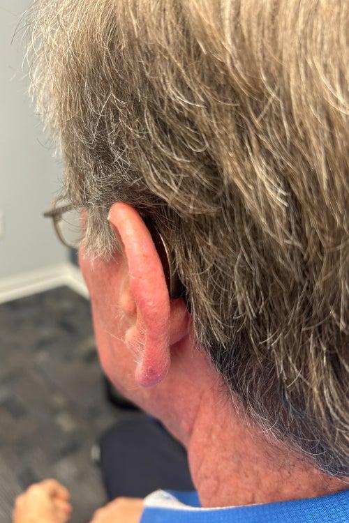 A man wearing Starkey Genesis AI hearing aids