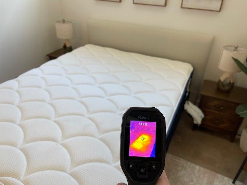 A heat gun shows a reading of 76.4 degrees F.