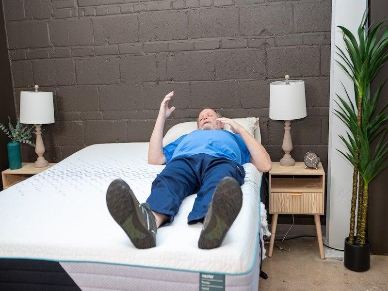 A man lying on his back on the Nectar Premier Hybrid mattress