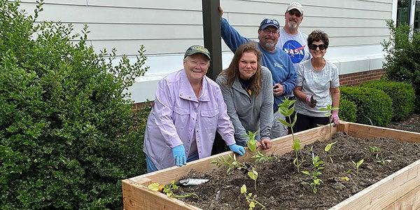 smiling older adults in outdoor garden