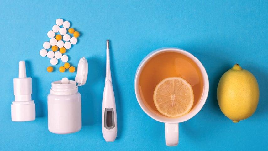 Close up of items that might help someone get better after getting RSV, including medication, hot tea, vitamin C, among others.