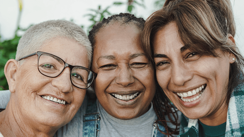 three smiling older women