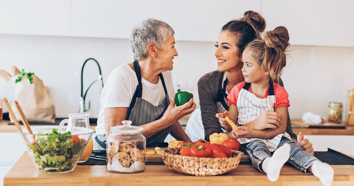 A senior woman is talking to her daughter and granddaughter at the island in her kitchen, smiling. More than 25% of SNAP-eligible households include adults over 60. Income guidelines change each year—we’ll help you see if you qualify for this helpful benefit.