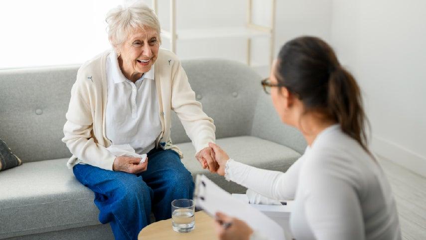 A senior caucasian woman is meeting with a healthcare professional to talk about precision health.