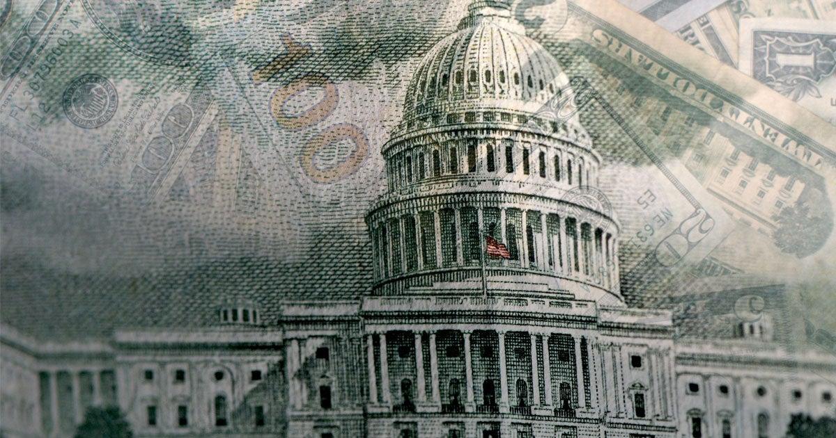 U.S. printed money overlays an external shot of the rotunda at the U.S. Capitol.