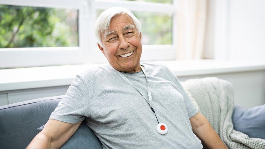 smiling man wearing medical alert pendant
