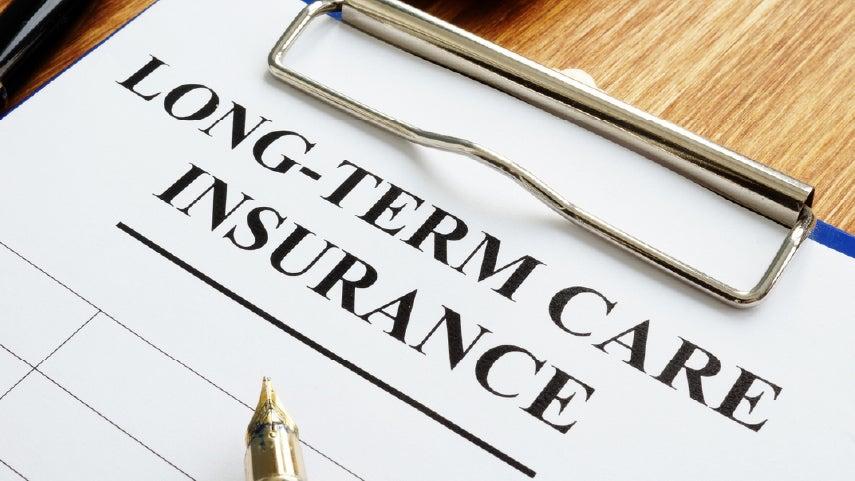 A closeup of a clipboard that has a form on it that says 'Long-Term Care Insurance'.