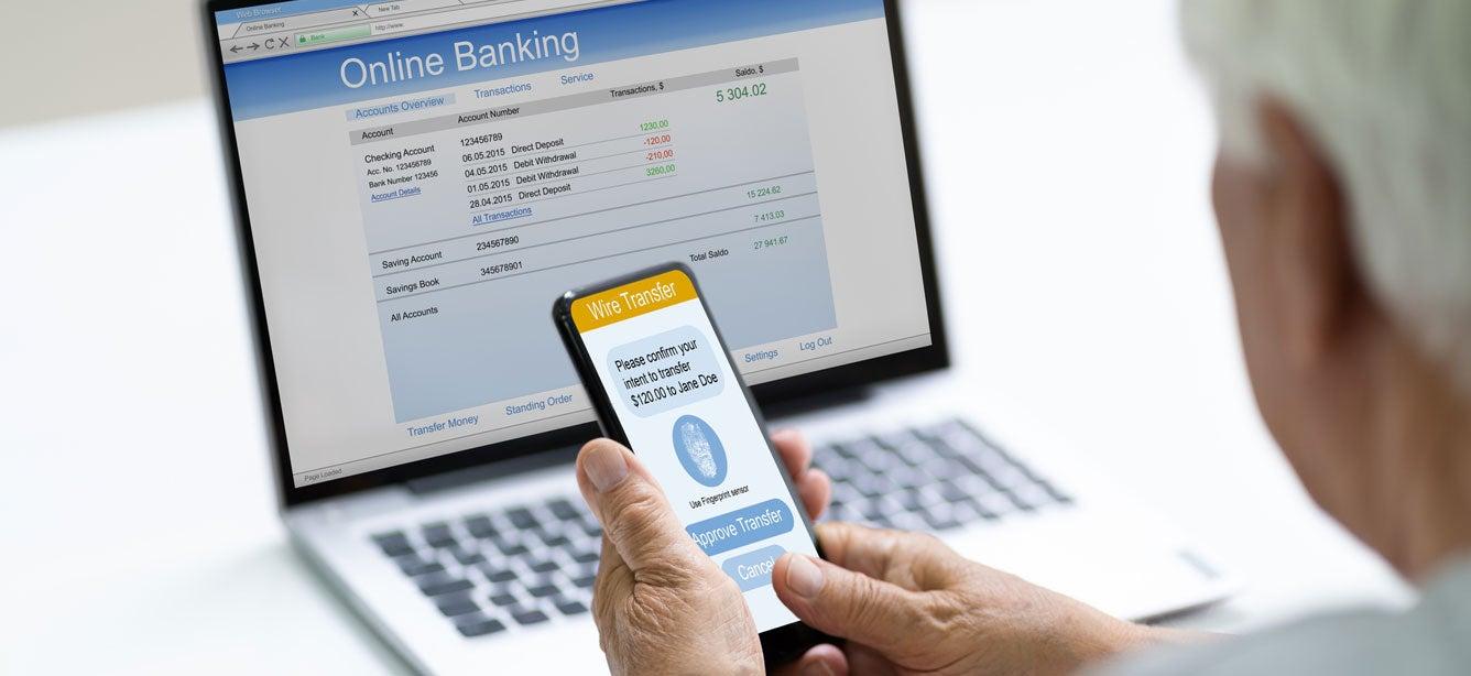 A senior caucasian man is transferring money to an unknown source using his cell phone.