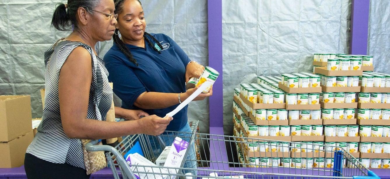 Services to Enhance Potential Cheri Hardin helps Dori Bryant with the food nutrition labels while shopping at Focus: HOPE, a local agency located in Detroit, Michigan that operates the Commodity Supplemental Food Program (CSFP) in a client choice model so that participants can select the foods they want in each food category.