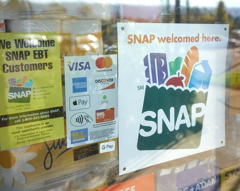 Close up of a SNAP sign on the window of grocery store.