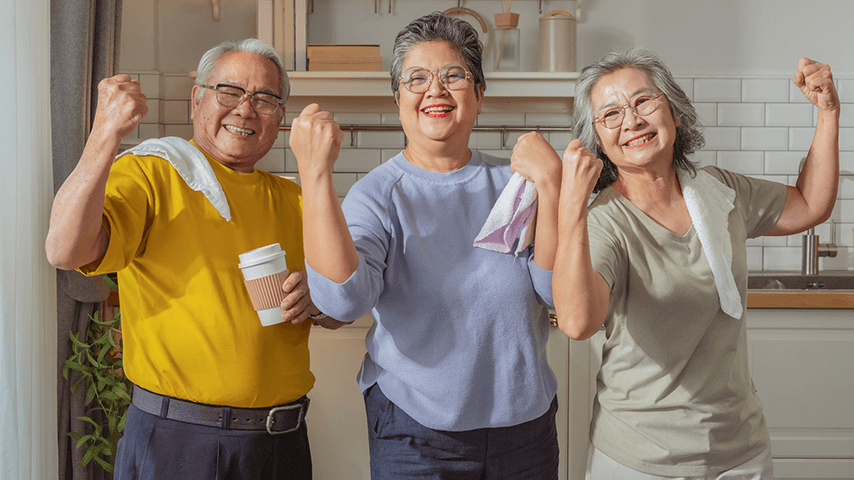 older Asian man and two women flexing and smiling