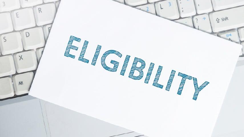 Paper resting on a keyboard that reads "ELIGIBILITY".